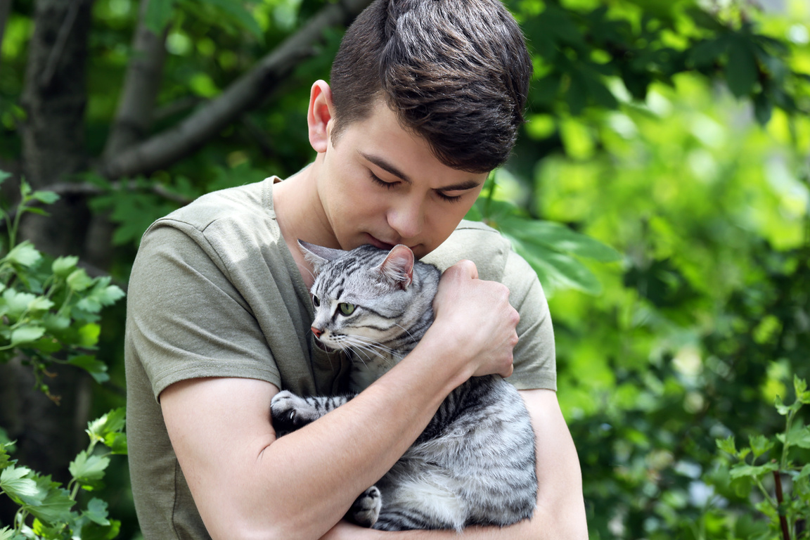 Handsome Young Man with Cute Cat Outdoors